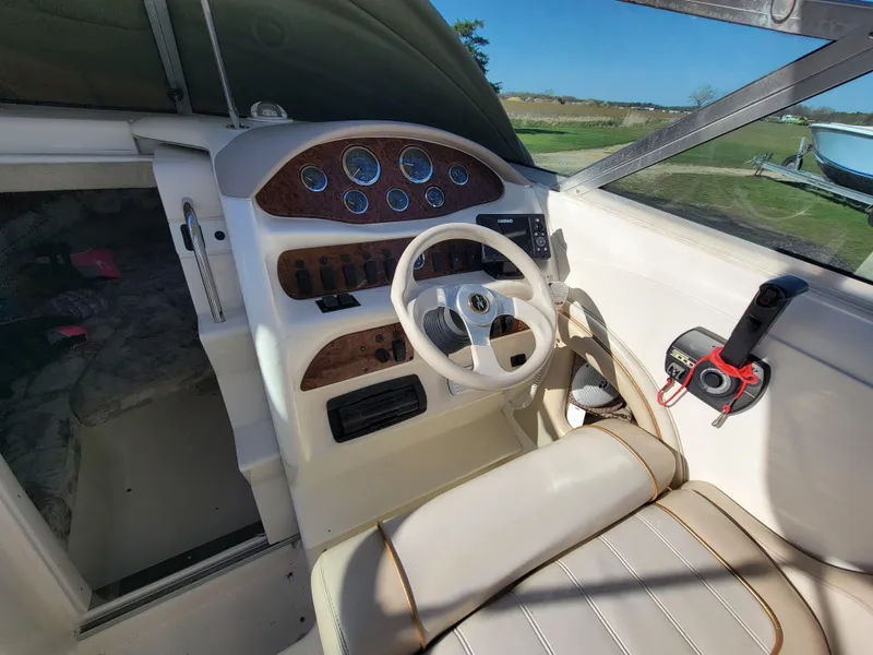 Slide: The Image of 1998 Sea Ray 260 Overnighter boat helm with steering wheel and control panel. - 5