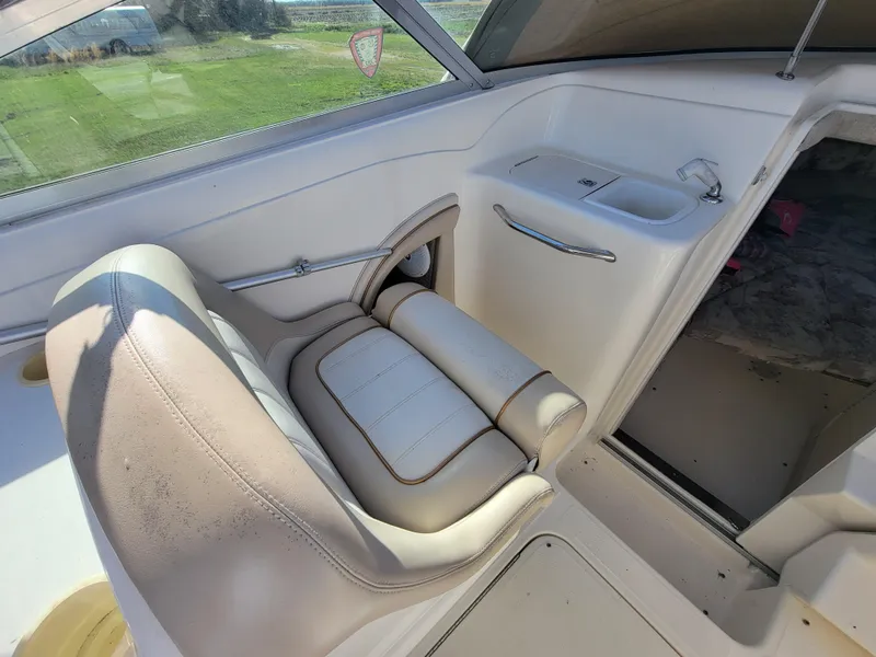 Slide: The Image of 1998 Sea Ray 260 Overnighter boat interior with white leather seating and cabin entrance. - 6