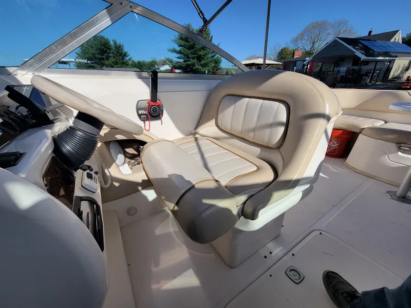 Slide: The Image of 1998 Sea Ray 260 Overnighter boat interior with beige captain's chair and control panel. - 7