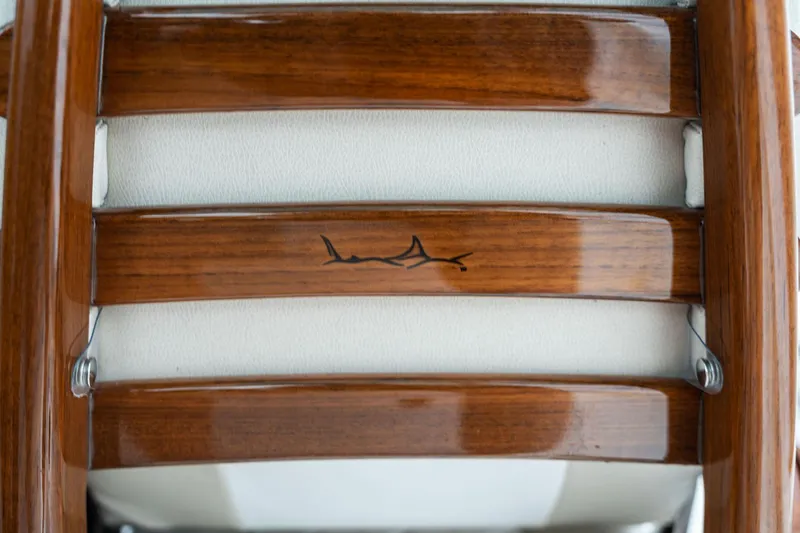 Slide: The Image of Close-up of 2025 Mag Bay 43 CC wooden boat seat with logo. - 26