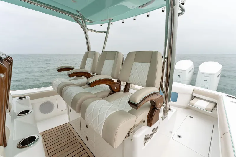 Slide: The Image of Luxurious seating on the 2025 Mag Bay 43 CC boat with ocean backdrop. - 31