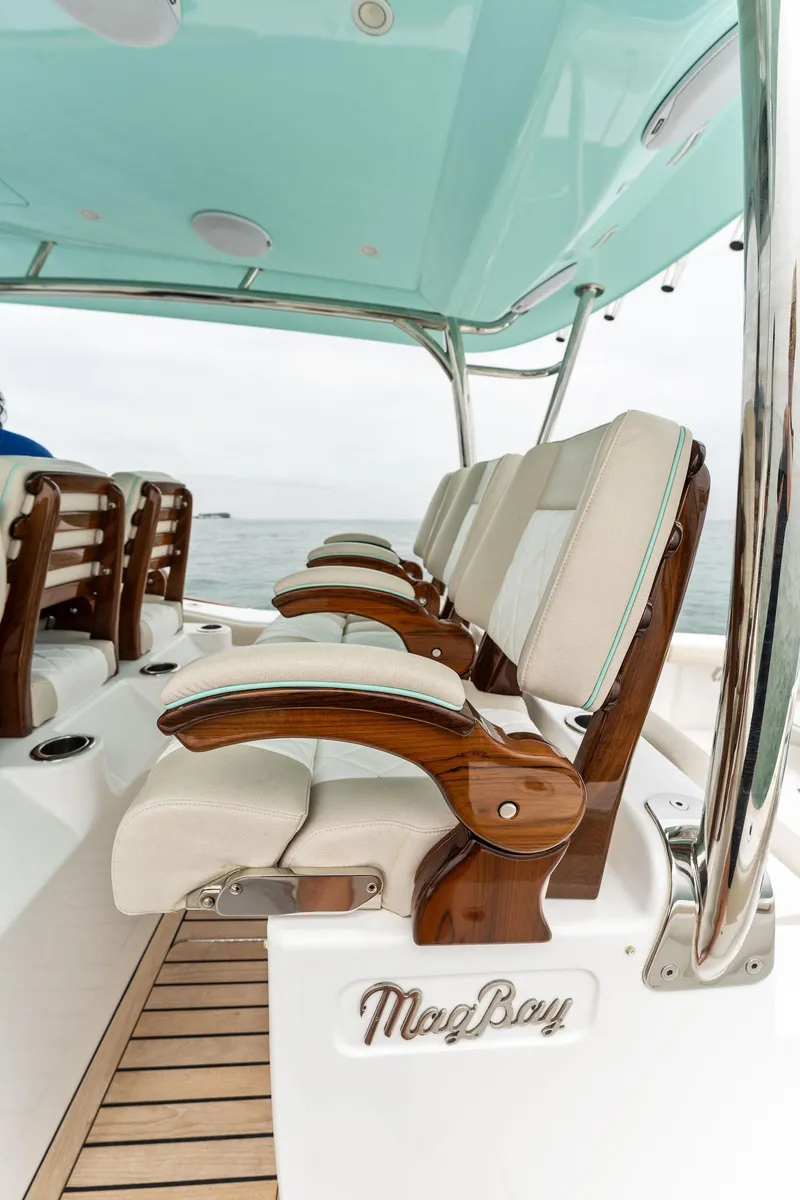 Slide: The Image of 2025 Mag Bay 43 CC boat with luxurious seating and teak accents. - 32