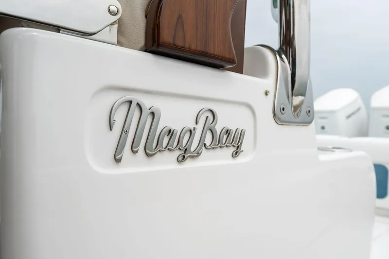 Slide: The Image of Mag Bay 43 CC 2025 model boat logo on white surface. - 33