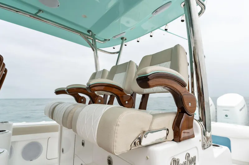 Slide: The Image of Mag Bay 43 CC 2025 boat with luxurious seating and ocean backdrop. - 34