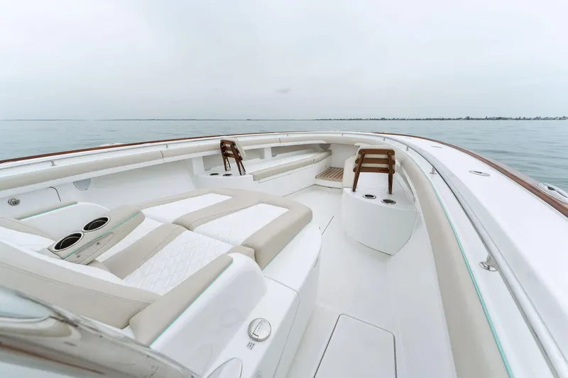 Slide: The Image of 2025 Mag Bay 43 CC boat with luxurious seating on calm waters. - 41