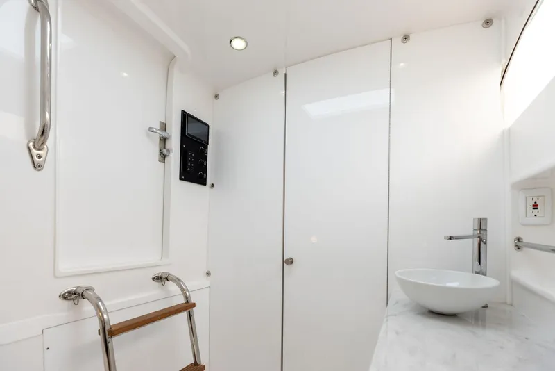 Slide: The Image of 2025 Mag Bay 43 CC boat interior with modern bathroom and sleek design. - 46