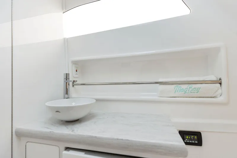Slide: The Image of 2025 Mag Bay 43 CC boat interior with modern sink and countertop. - 47