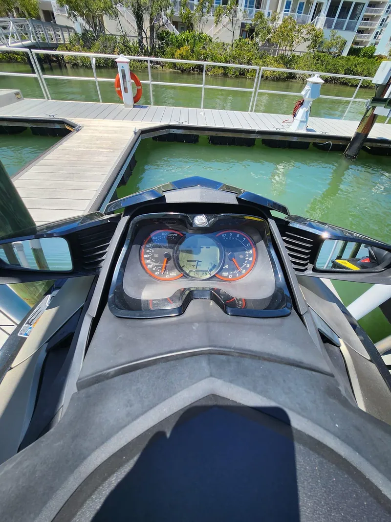 Slide: The Image of 2017 Sea-Doo Limited GTX dashboard view at a marina. - 2