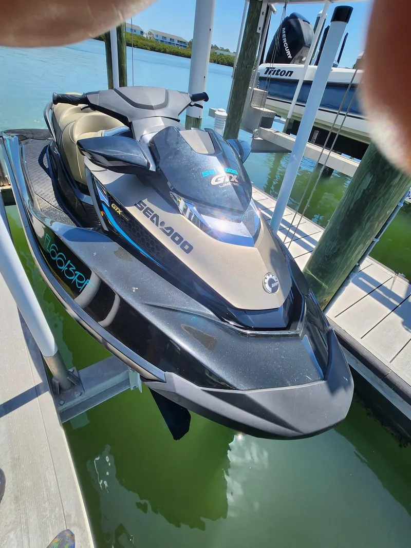 Slide: The Image of 2017 Sea-Doo Limited GTX jet ski docked on a lift by the water. - 3