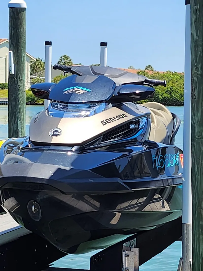 Slide: The Image of 2017 Sea-Doo Limited GTX jet ski docked on a lift by the water. - 7