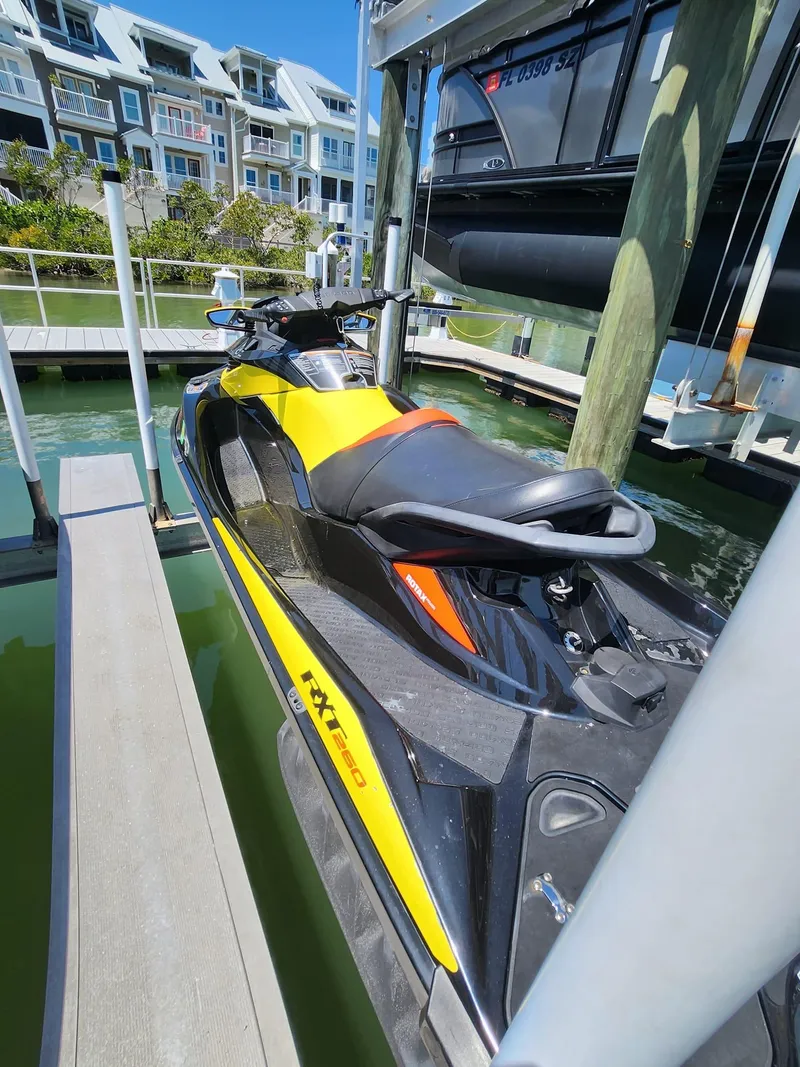 Slide: The Image of 2015 Sea-Doo RXT 260 jet ski docked at a marina. - 1