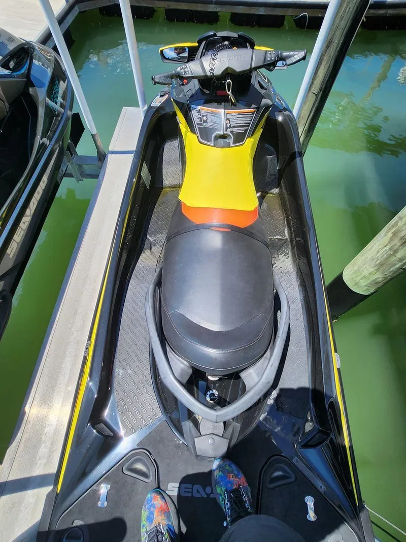 Slide: The Image of 2015 Sea-Doo RXT 260 jet ski docked on calm water. - 3