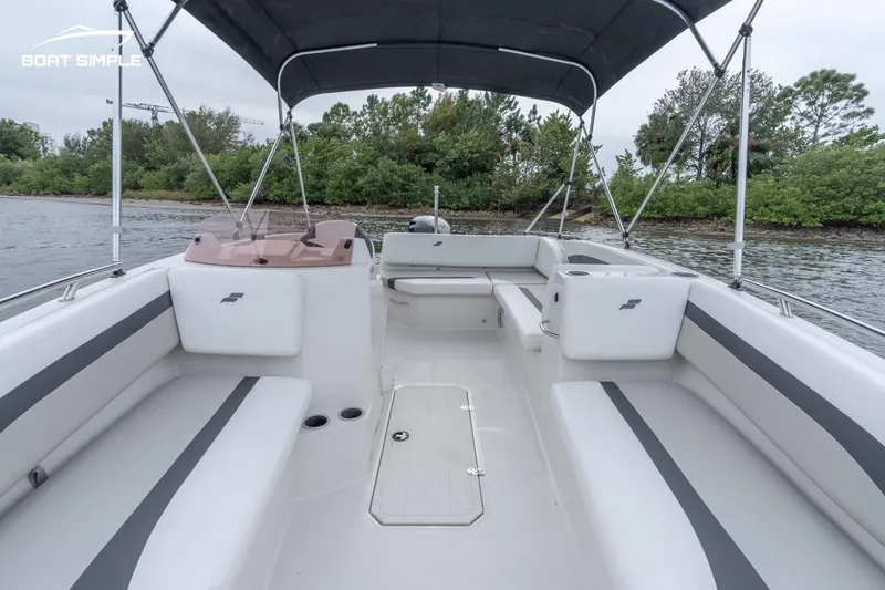 Slide: The Image of 2022 Starcraft SVX 171 OB boat interior with spacious seating and canopy. - 9