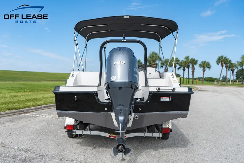 Slide: The Image of 2022 Starcraft SVX 191 OB boat with 150 HP engine, rear view, on trailer. - 3