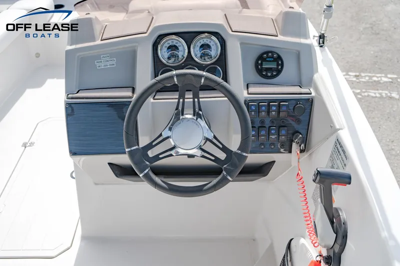 Slide: The Image of 2022 Starcraft SVX 191 OB boat dashboard with steering wheel and control panel. - 7