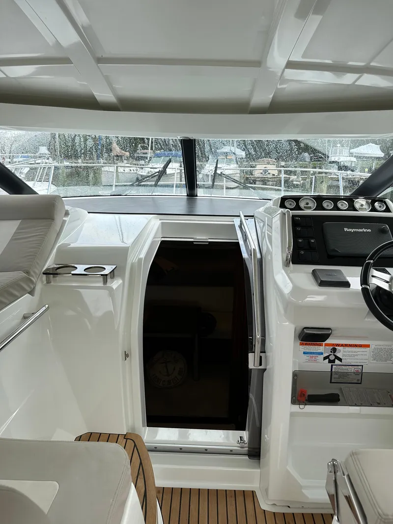 Slide: The Image of 2016 Jeanneau Leader 36 cockpit with helm and cabin entrance. - 12