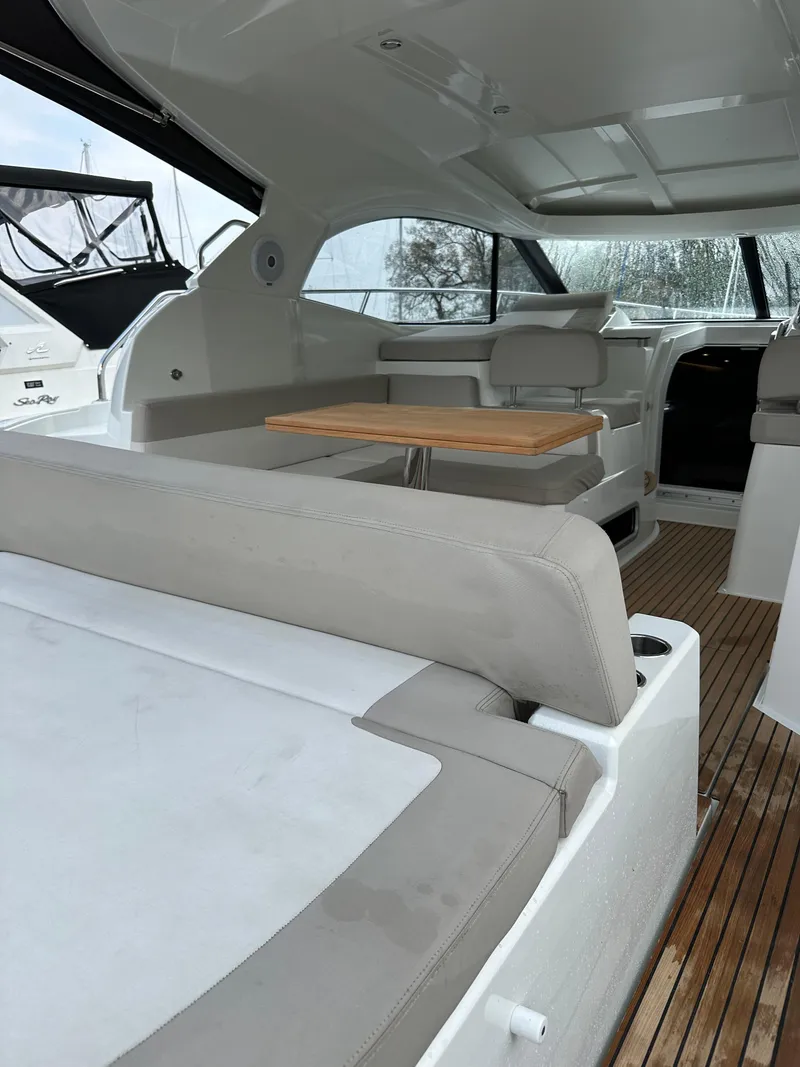 Slide: The Image of 2016 Jeanneau Leader 36 interior with seating and wooden table. - 16