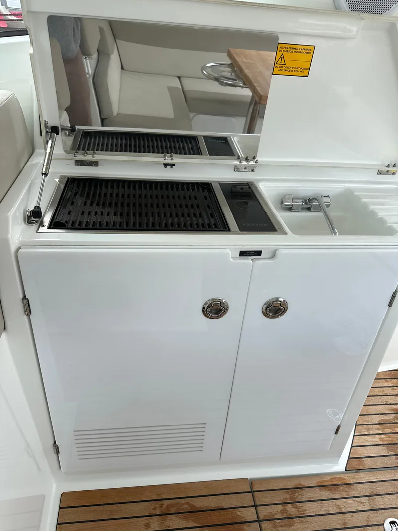 Slide: The Image of Outdoor kitchenette on a 2016 Jeanneau Leader 36 yacht with grill and sink. - 26