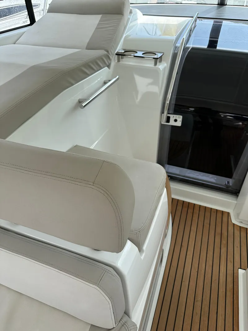 Slide: The Image of 2016 Jeanneau Leader 36 interior with beige seating and wooden flooring. - 30