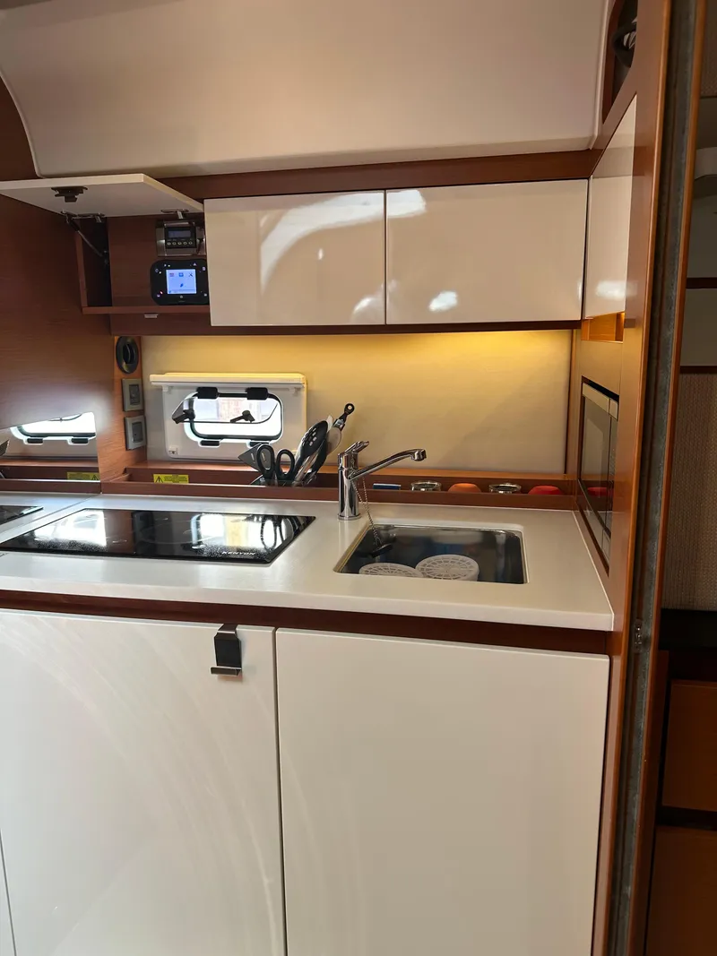 Slide: The Image of Modern kitchen area in a 2016 Jeanneau Leader 36 yacht with sink and stove. - 39