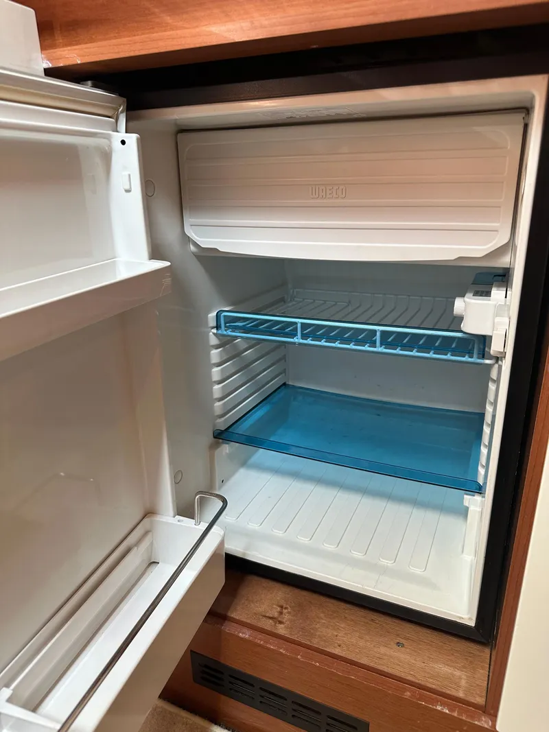 Slide: The Image of Open refrigerator inside a 2016 Jeanneau Leader 36 boat. - 43