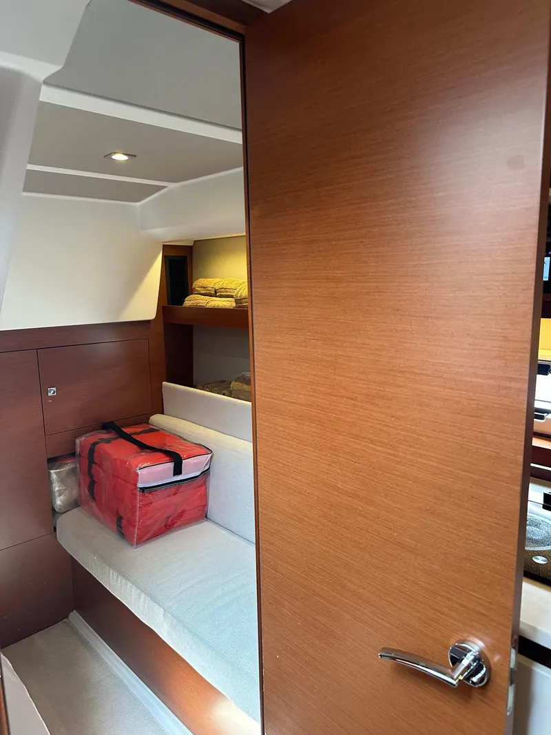 Slide: The Image of Interior cabin of 2016 Jeanneau Leader 36 yacht with wooden finish and seating area. - 50