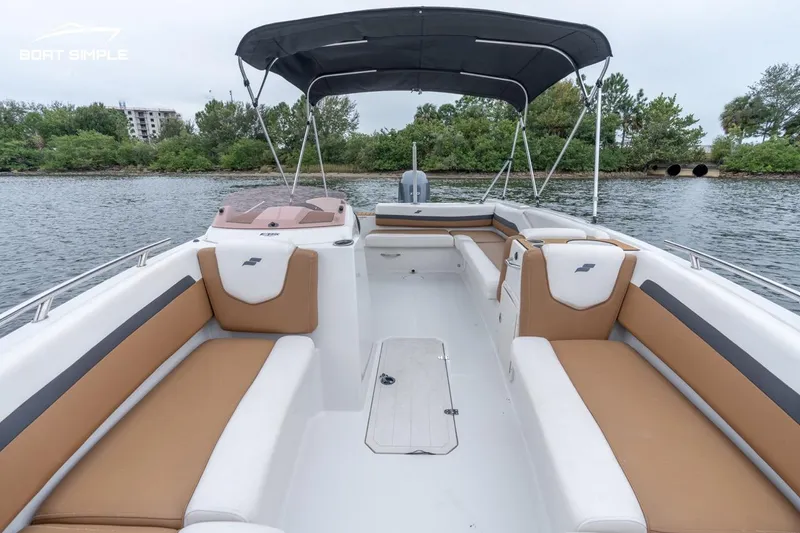 Slide: The Image of 2022 Starcraft SVX 211 OB boat with spacious seating and canopy on a serene waterway. - 9