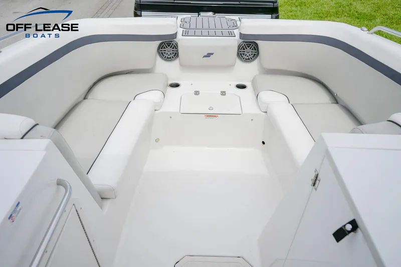 Slide: The Image of 2022 Starcraft SVX 231 OB boat interior with white seating and storage compartments. - 4