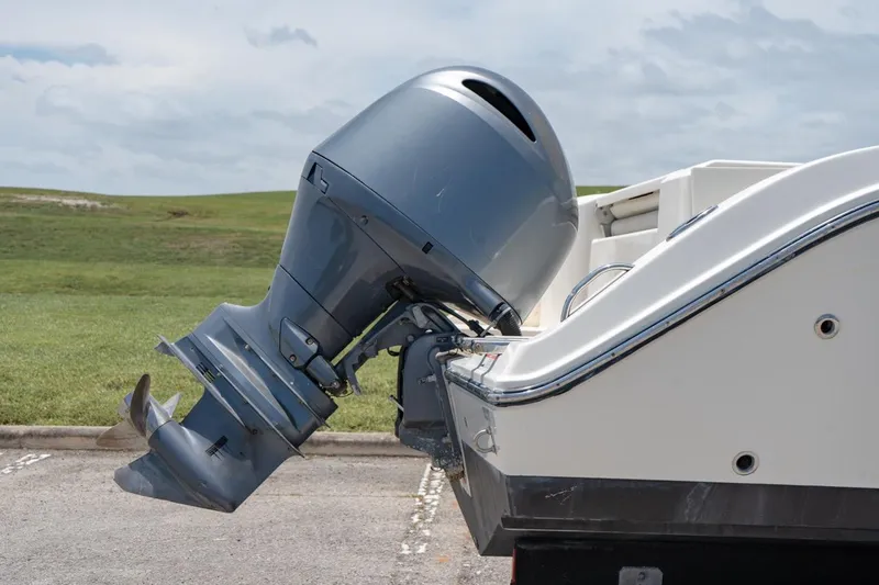 Slide: The Image of 2021 Cobia 201 Center Console boat with outboard motor in parking lot. - 3