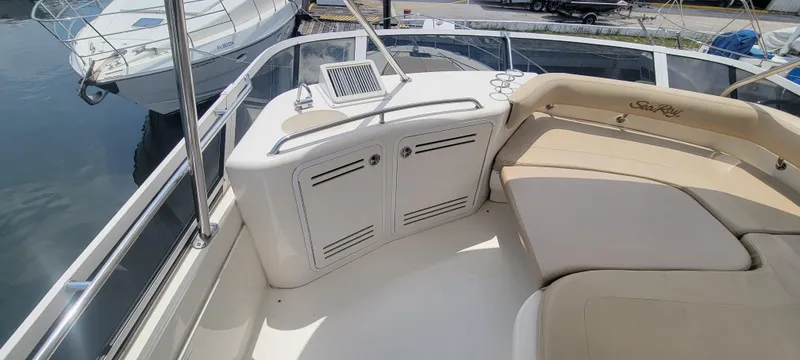 Slide: The Image of 2004 Sea Ray 480 Sedan Bridge boat interior with seating and storage compartments. - 13