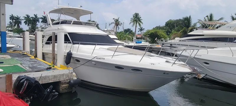 Slide: The Image of 2004 Sea Ray 480 Sedan Bridge yacht docked at a marina. - 2