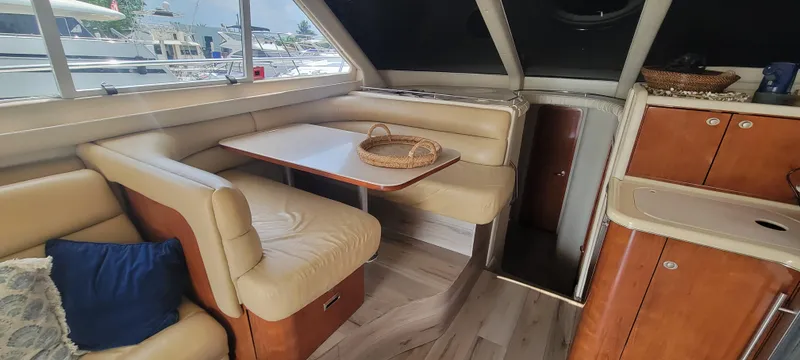 Slide: The Image of Interior of 2004 Sea Ray 480 Sedan Bridge with dining area and kitchenette. - 22