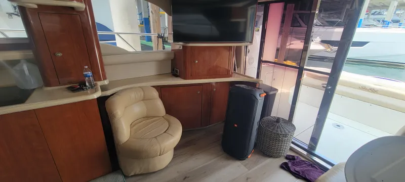 Slide: The Image of Interior of a 2004 Sea Ray 480 Sedan Bridge yacht with seating and TV. - 24