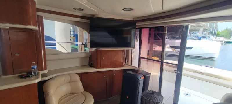 Slide: The Image of Interior of 2004 Sea Ray 480 Sedan Bridge yacht with TV and leather seating. - 25