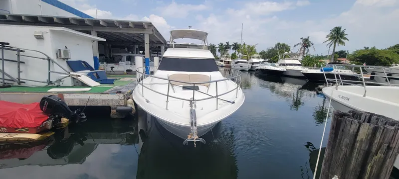 Slide: The Image of 2004 Sea Ray 480 Sedan Bridge docked at a marina with other boats. - 3