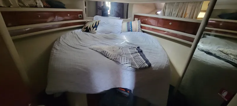 Slide: The Image of Cozy bedroom in 2004 Sea Ray 480 Sedan Bridge yacht with plush bedding. - 33
