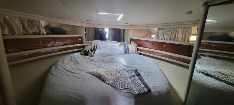 Slide: The Image of Luxurious bedroom in 2004 Sea Ray 480 Sedan Bridge yacht with cozy bedding. - 34