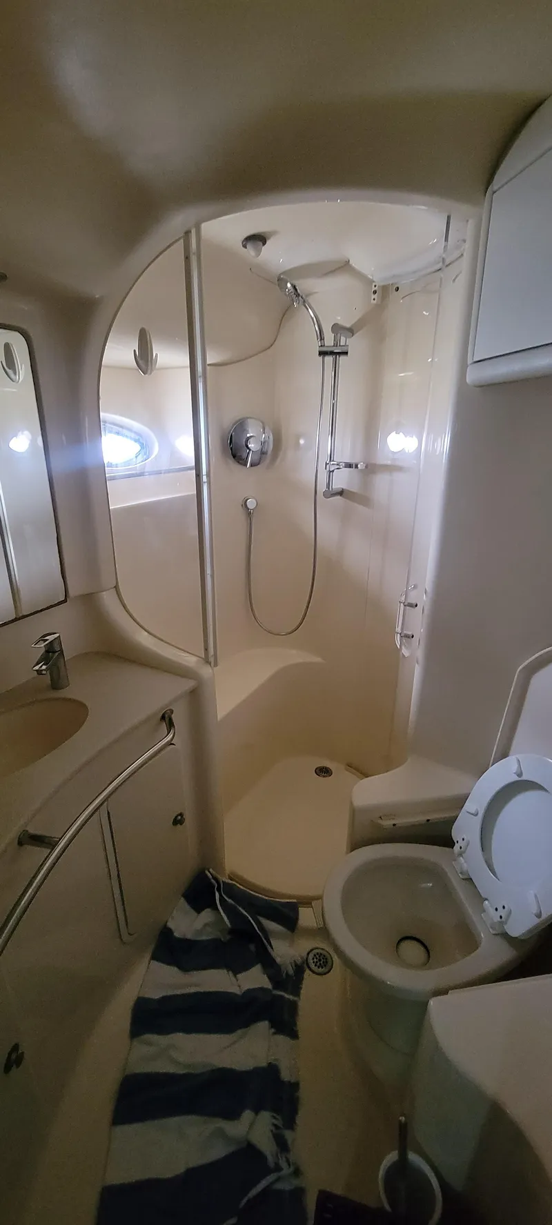 Slide: The Image of 2004 Sea Ray 480 Sedan Bridge bathroom with shower, sink, and toilet. - 35