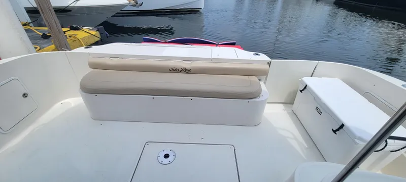 Slide: The Image of 2004 Sea Ray 480 Sedan Bridge boat deck with cushioned seating and storage. - 4