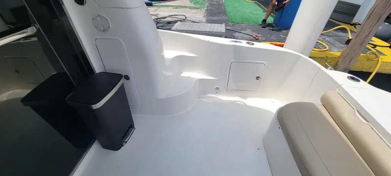 Slide: The Image of 2004 Sea Ray 480 Sedan Bridge boat deck with seating and storage compartments. - 5