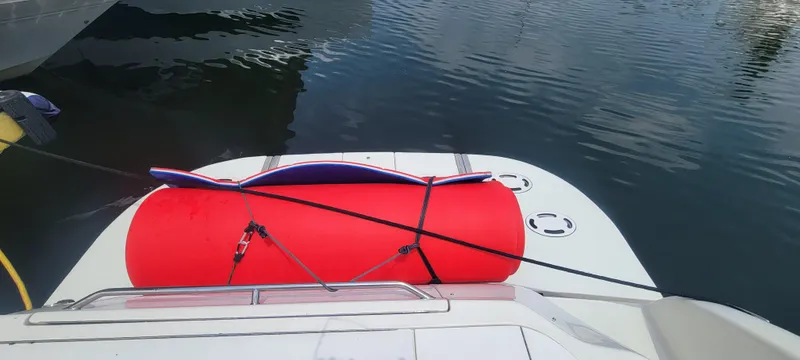 Slide: The Image of 2004 Sea Ray 480 Sedan Bridge with red inflatable tube on swim platform. - 7