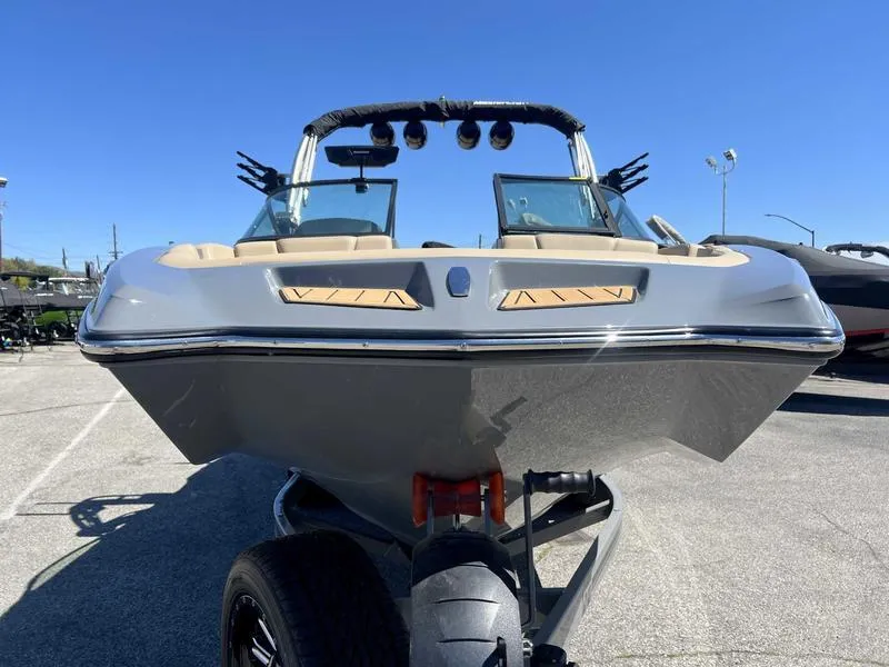 Slide: The Image of 2023 MasterCraft XT24 boat on trailer, front view, sunny day. - 4