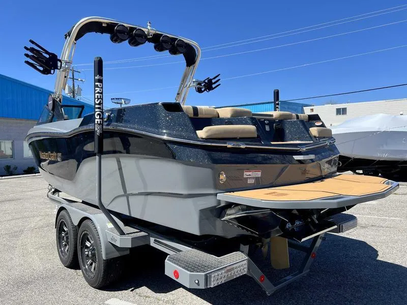 Slide: The Image of 2023 MasterCraft XT24 boat on a trailer, rear view, in a parking lot. - 7