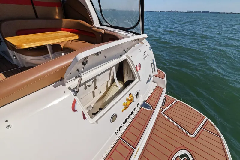 Slide: The Image of 2006 Sea Ray 320 Sundancer boat with open storage compartment on deck. - 10