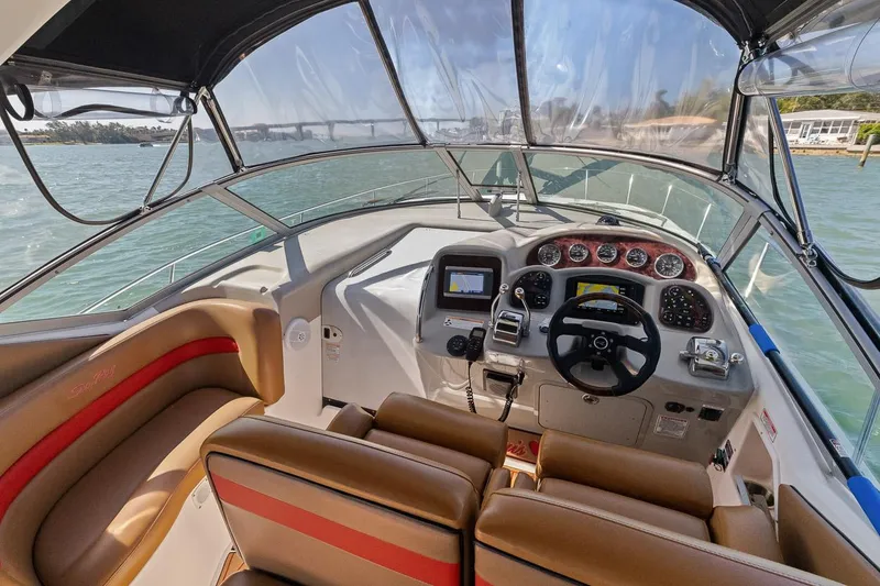 Slide: The Image of 2006 Sea Ray 320 Sundancer boat cockpit with modern navigation equipment. - 12