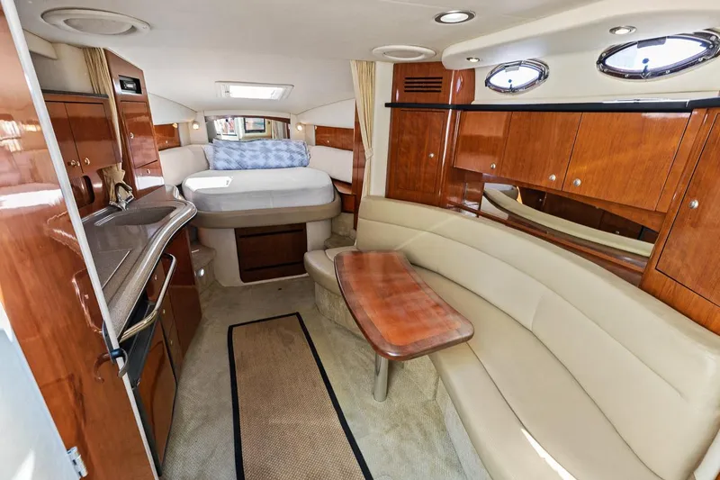 Slide: The Image of Interior of 2006 Sea Ray 320 Sundancer with bed, kitchenette, and seating area. - 16