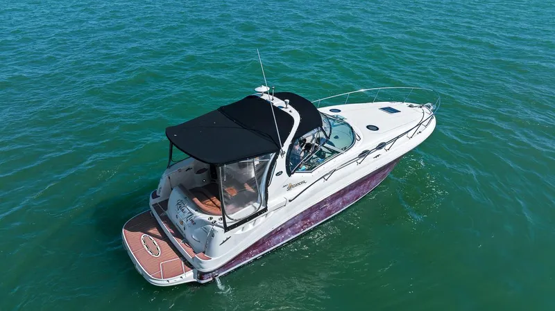 Slide: The Image of 2006 Sea Ray 320 Sundancer boat cruising on open water. - 17