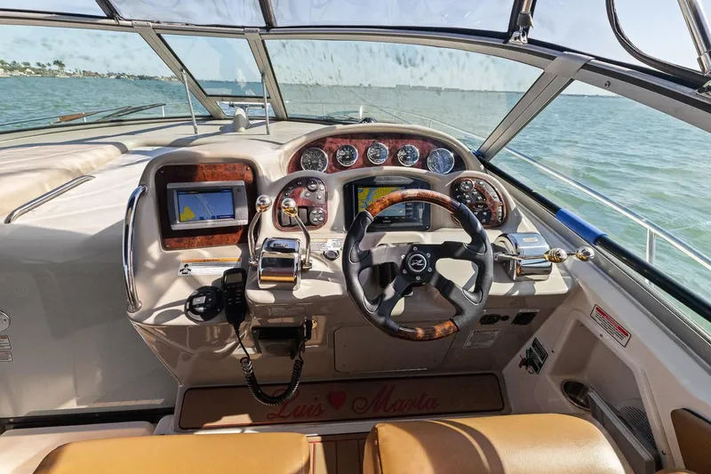 Slide: The Image of 2006 Sea Ray 320 Sundancer helm with navigation system and leather seats. - 2
