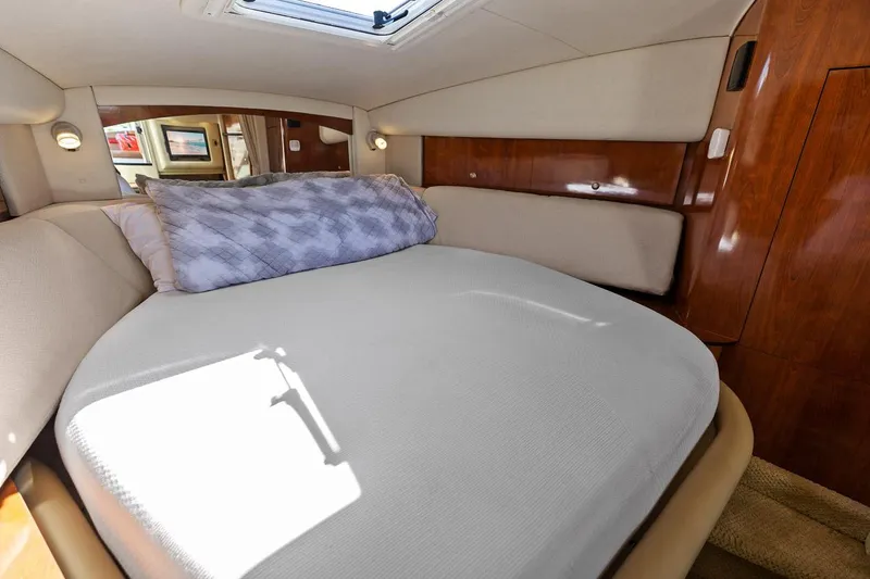 Slide: The Image of 2006 Sea Ray 320 Sundancer cabin with bed and skylight. - 25