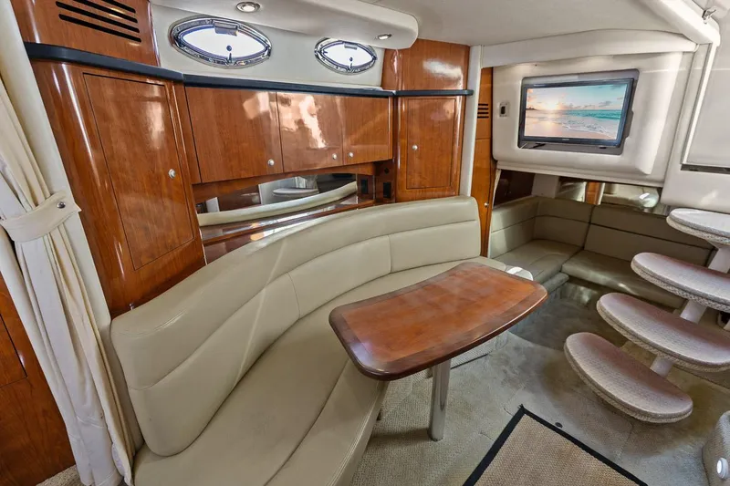 Slide: The Image of Interior of 2006 Sea Ray 320 Sundancer with leather seating and wooden cabinetry. - 28